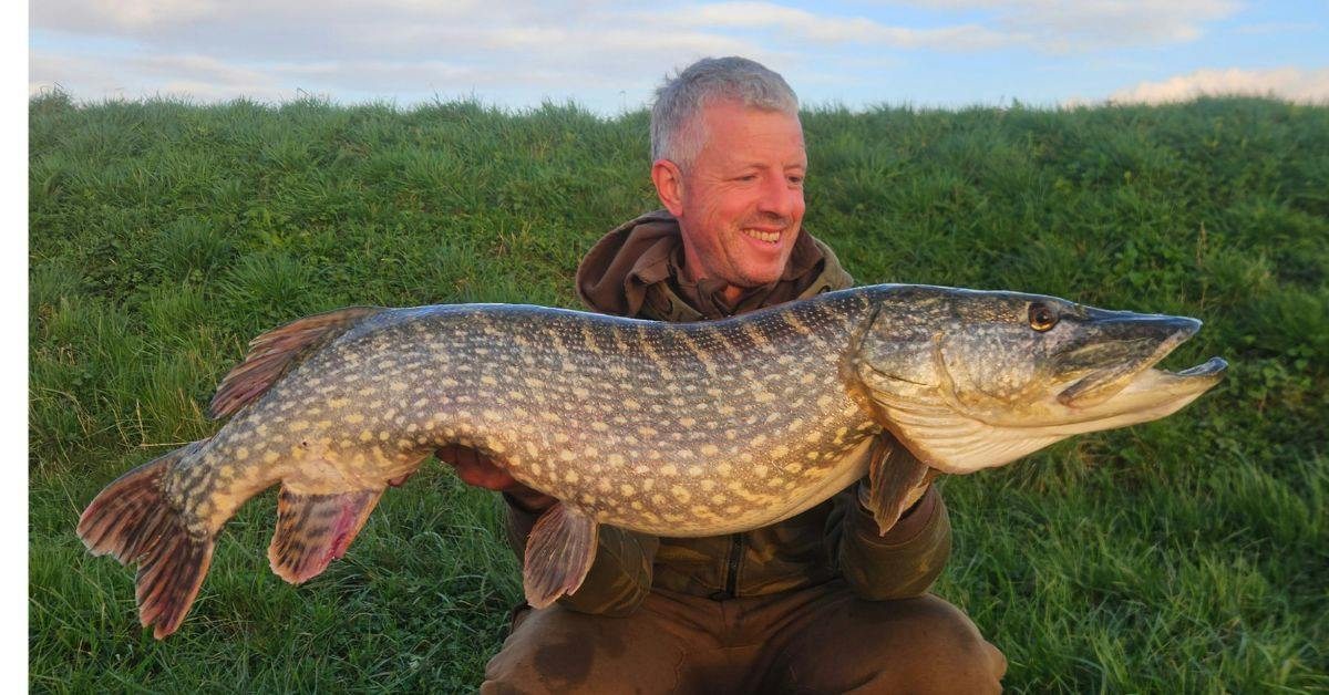 Ian Cousloon holding a hard-earned pike from the River
