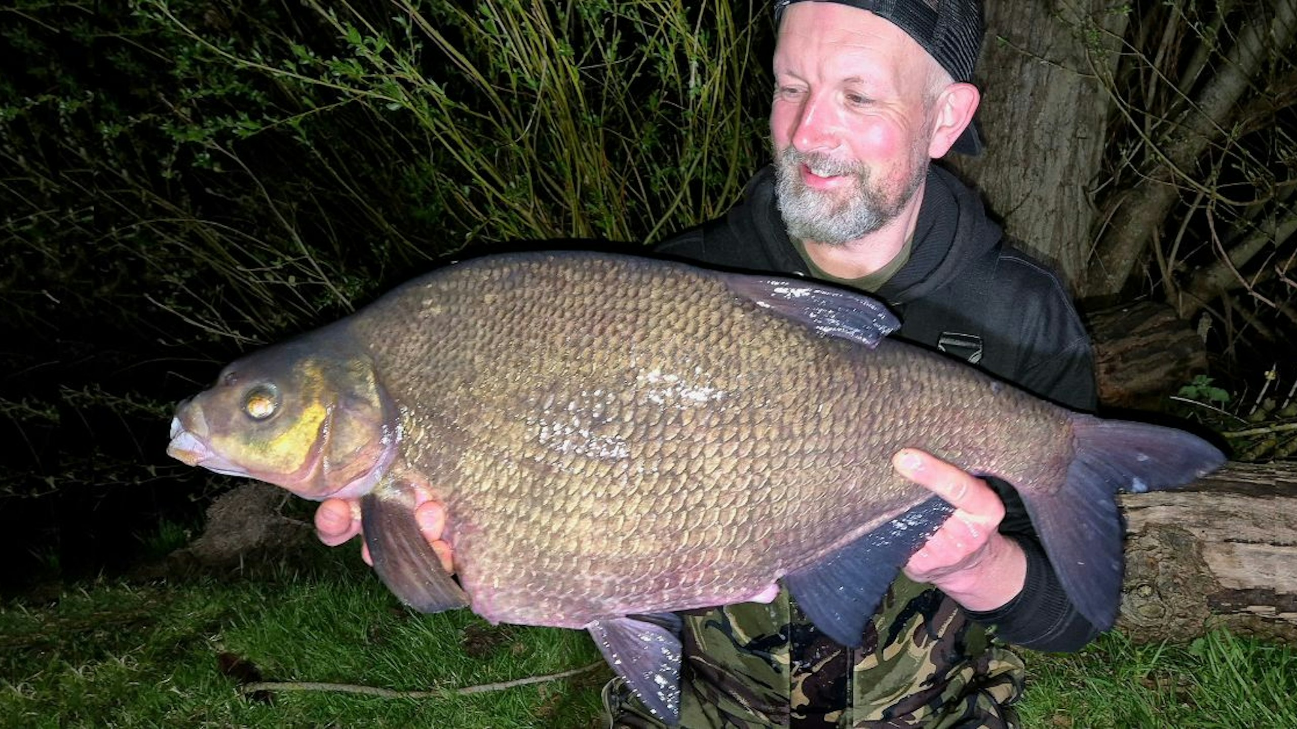 Angler holding a massive bream