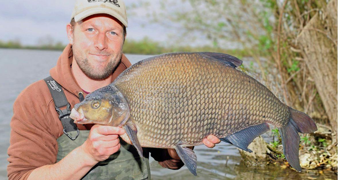 angler Adam Riches holding up a giant bream