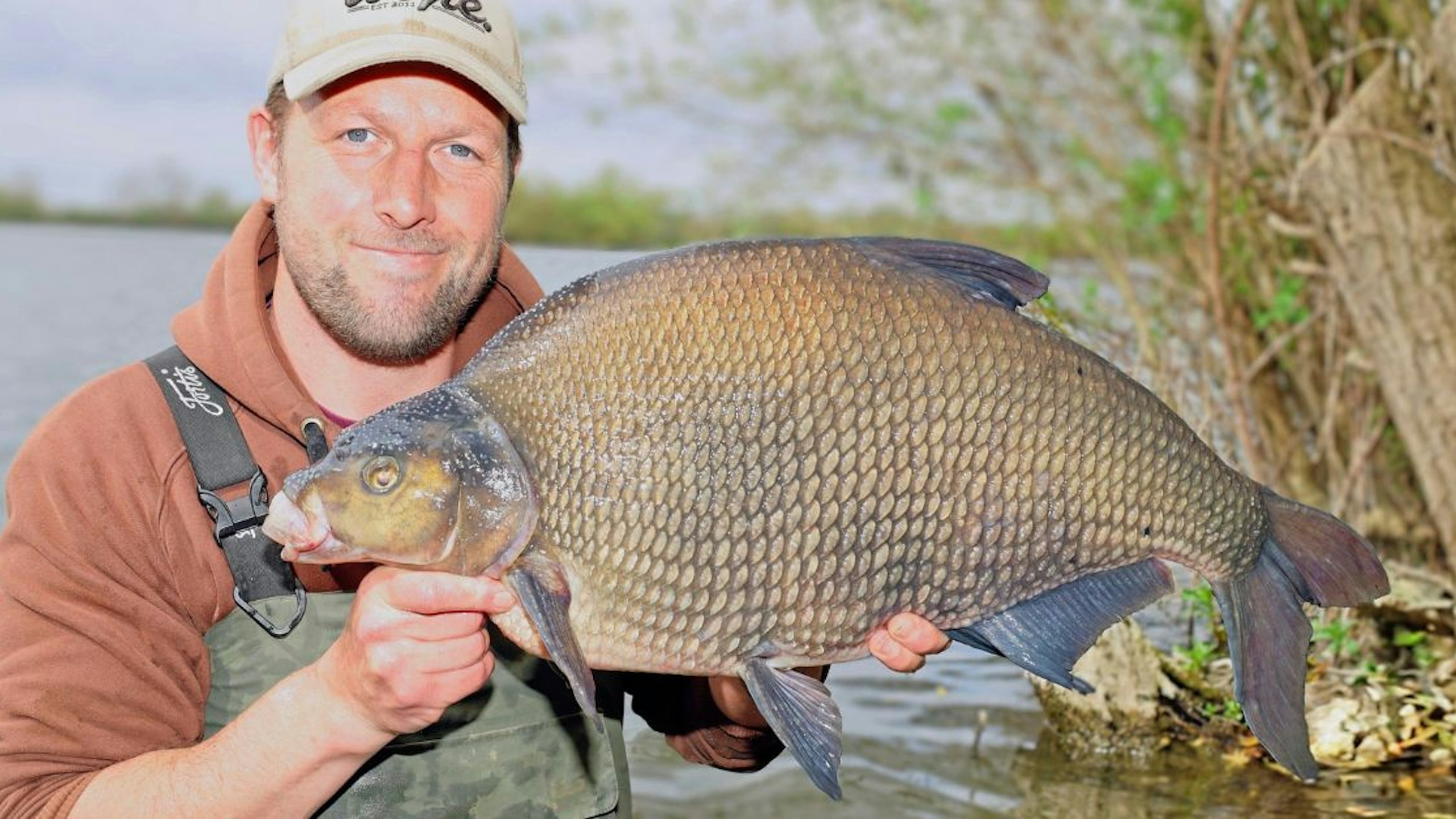 angler Adam Riches holding up a giant bream