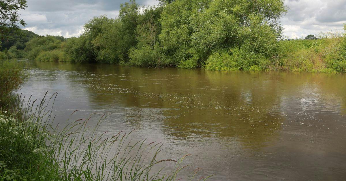 Foam and discoloured water in the River Wye showing suspected pollution
