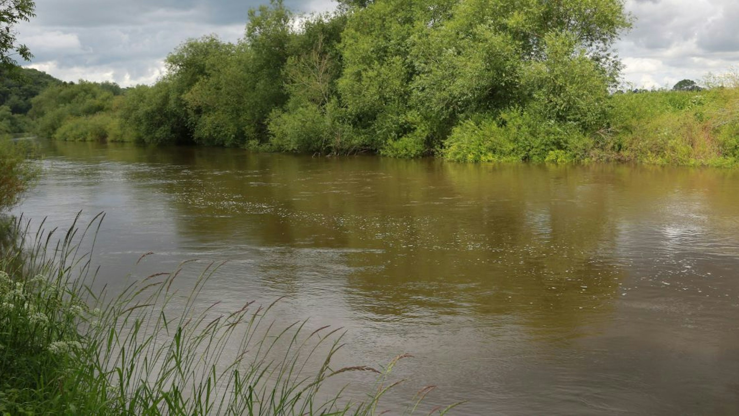 Foam and discoloured water in the River Wye showing suspected pollution