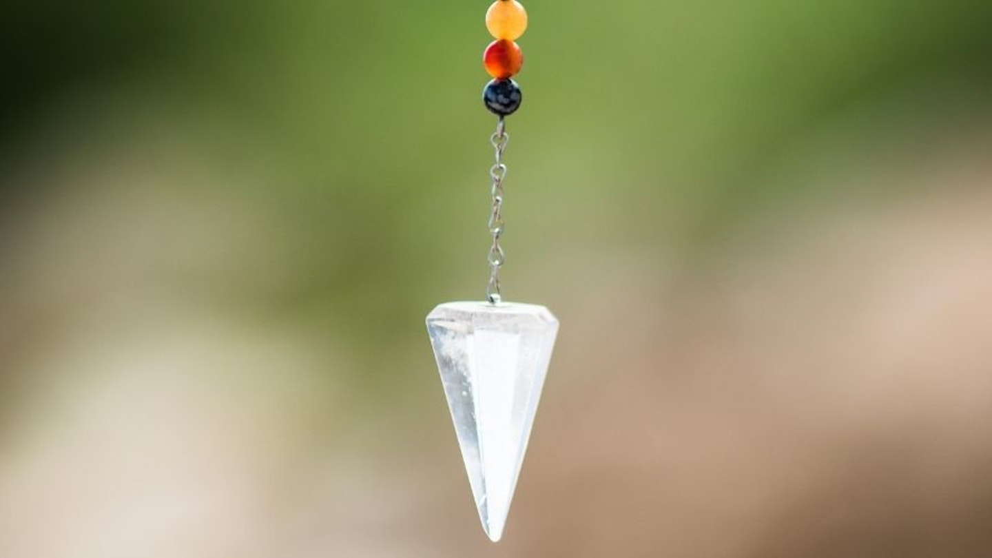A close up of a pendulum necklace