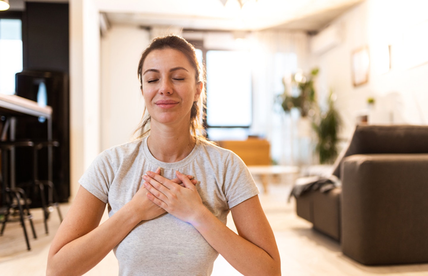 Young woman meditating at home.