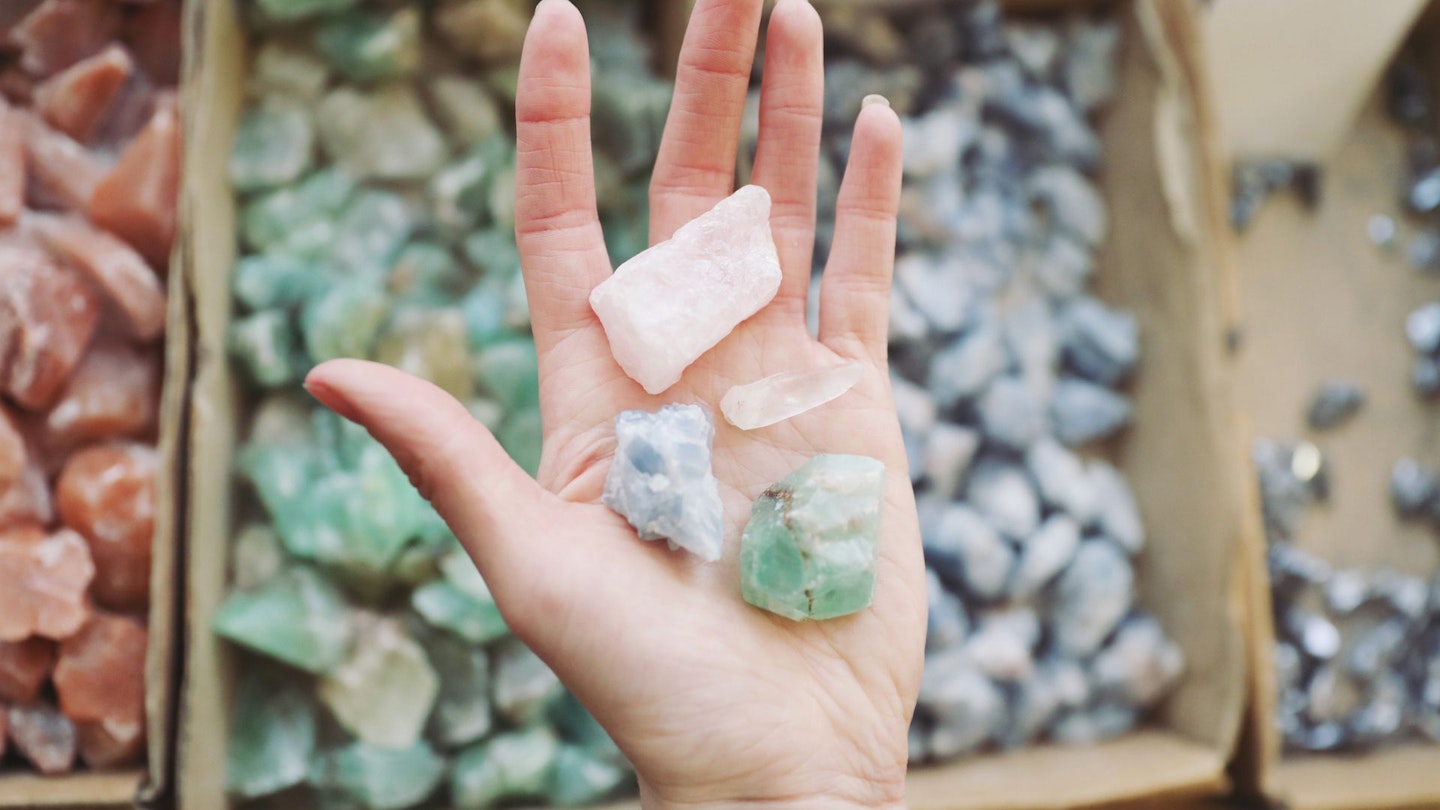 Cropped Hand Of Woman Holding Crystals In Store - stock photo