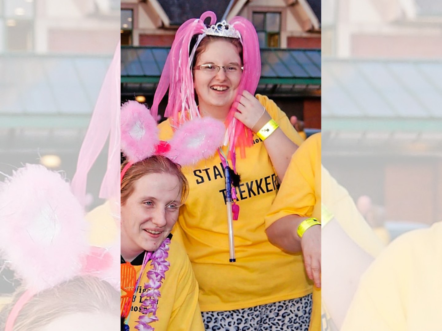 Woman with pink headress and yellow T-shirt