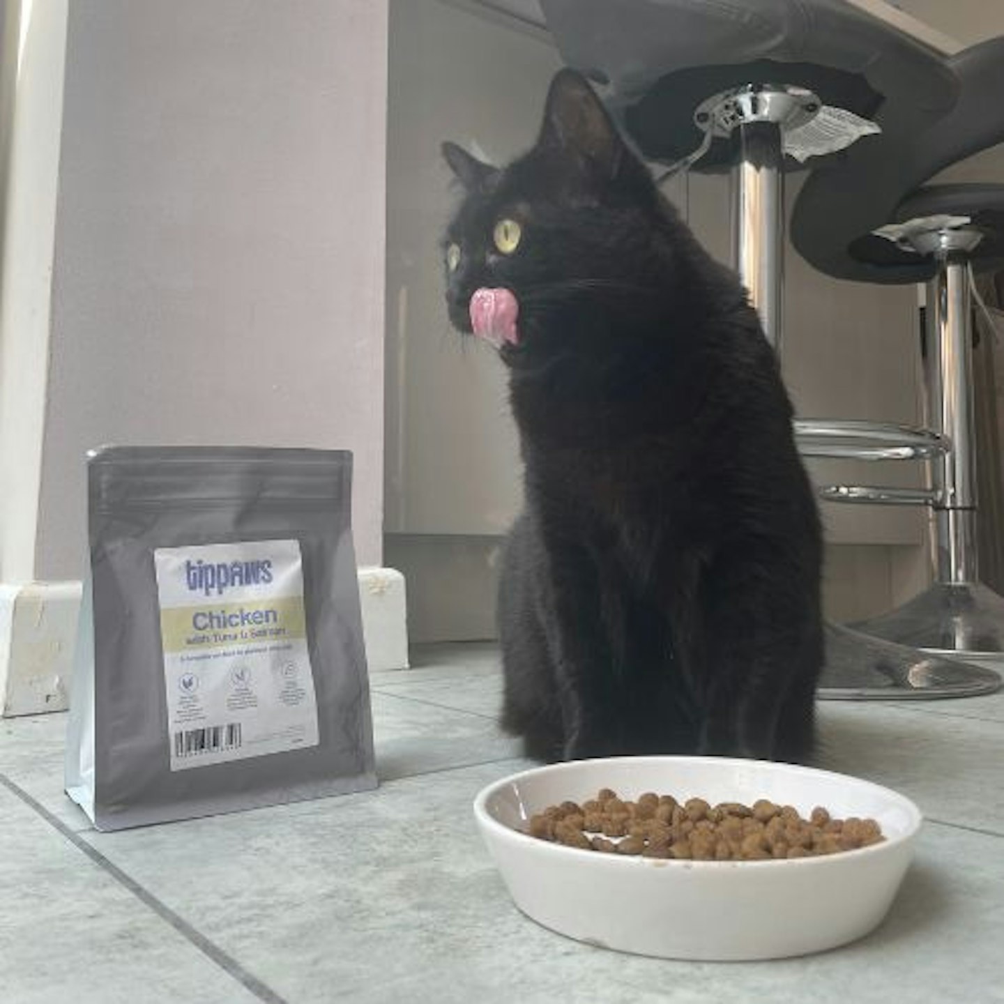 Piper's Cat, Myrtle, is licking her lips with her new Tippaws food.,