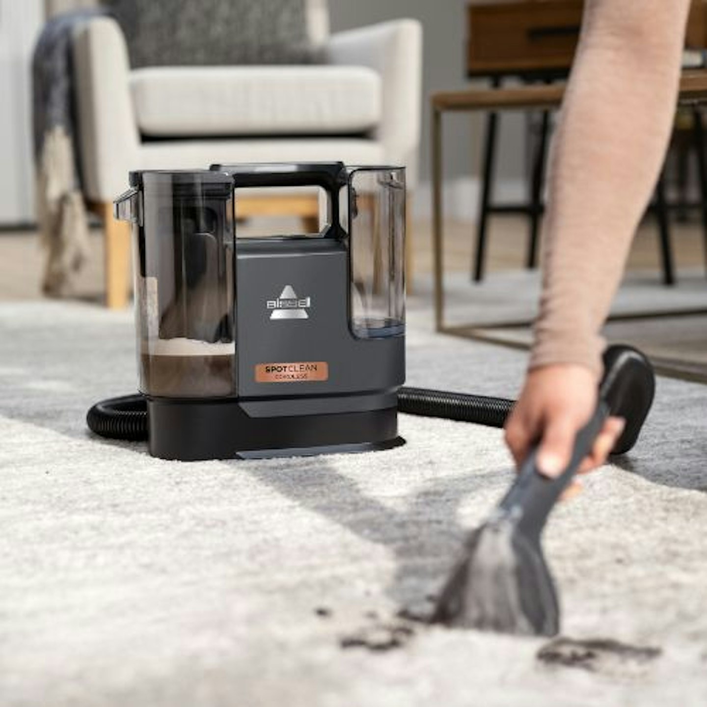 Bissell SpotClean Cordless Spot Carpet Cleaner cleaning mess on a carpet