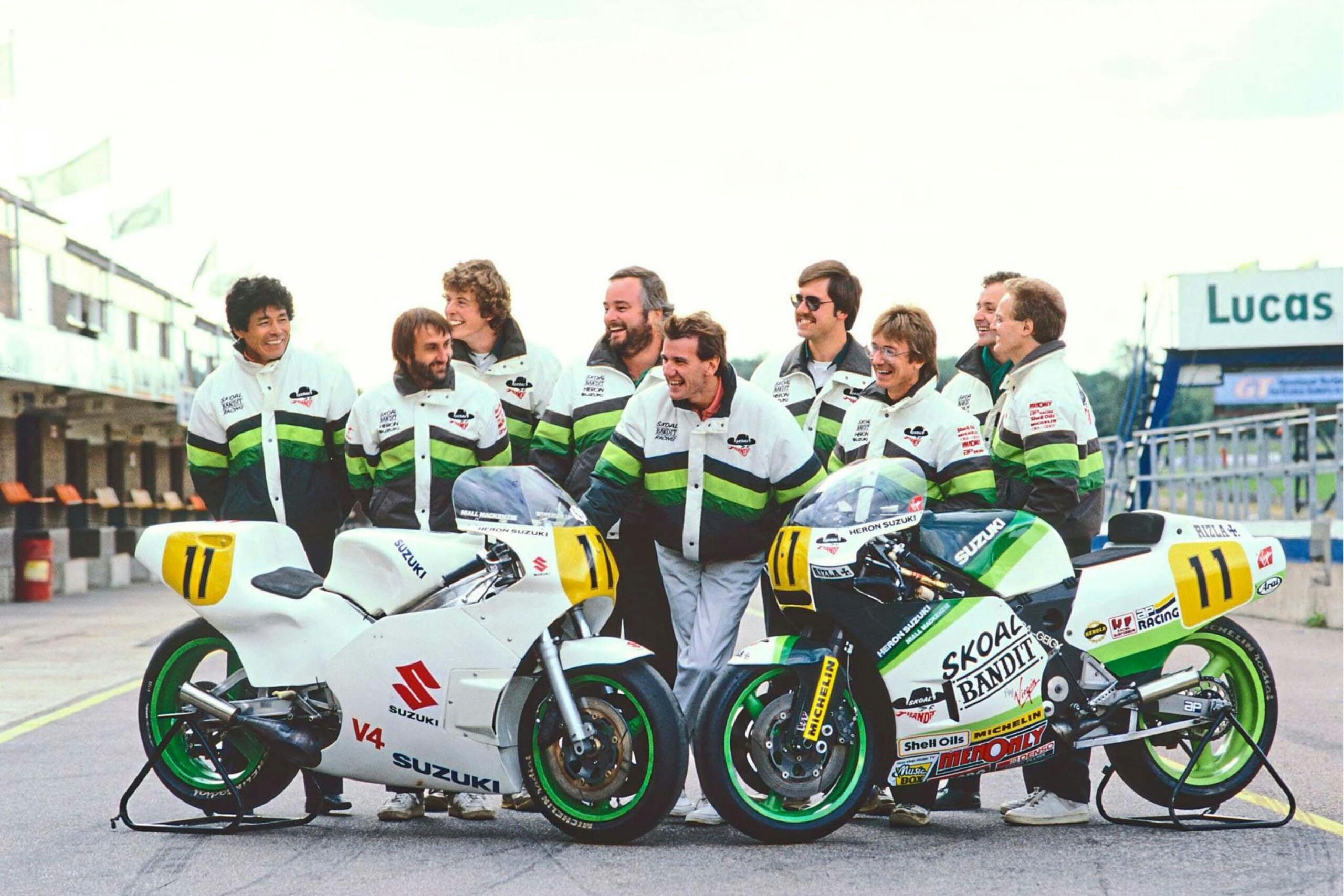 Paul (back row, tinted glasses) and the rest of the Skoal Bandit crew crack up at something being said by Niall Mackenzie (out of shot on the left). They’re at the Donington test in 1988